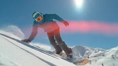 SLOW MOTION: Girl snowboarder riding fresh powder snow in backcountry mountain