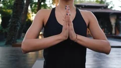 Pretty woman with oriental face practicing yoga, namaste gratitude mudra alone