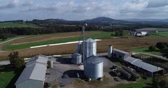 Aerial view pushing in towards American flag at top of grain silo with