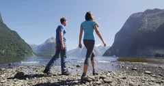 New Zealand Tourists hiking in Milford Sound by Mitre Peak in Fiordland