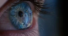 close up macro eye opening city lights reflecting on iris looking at beautiful