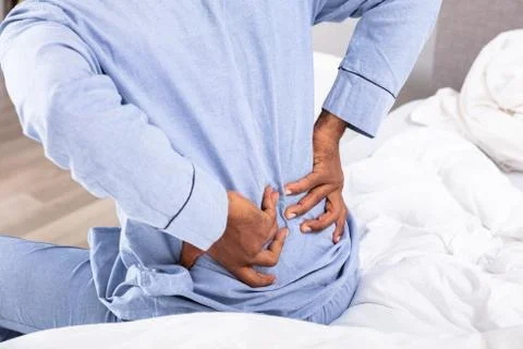 Young Man Sitting On Bed Suffering From Back Pain xkwx back, pain, backpain, orthopedic, man, bed, suffering, african, backaches, posture, bad, american, orthopedics, sit, home, lower, mattress, sick, ache, side, stress, black, backache, unhappy, people, white, problem, health, person, upset, guy, healthcare, uncomfortable, care, trouble, sheet, blanket, bedroom, ill, young, discomfort, duvet, painful, sitting, male, afro, sickness, bedtime, adult