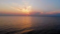 Aerial dolly shot towards the setting sun Chesapeake Bay, Cape Charles, Va