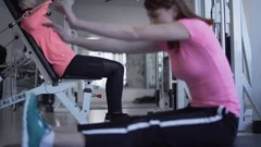 Two females are doing exercises in the gym People in the gym Fitness Therapy