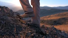 Close up of feet climber male hiker traveler man walking and climbing up in