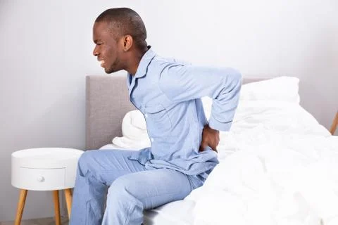 Young Man Sitting On Bed Suffering From Back Pain xkwx back, pain, backpain, orthopedic, man, bed, suffering, african, backaches, posture, bad, american, orthopedics, sit, home, lower, mattress, sick, ache, side, stress, black, backache, unhappy, people, white, problem, health, person, upset, guy, healthcare, uncomfortable, care, trouble, sheet, blanket, bedroom, ill, young, discomfort, duvet, painful, sitting, male, afro, sickness, bedtime, adult