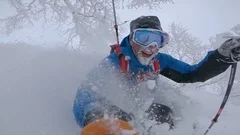 SLOW MOTION: Happy friends enjoying a perfect winter day skiing in fresh snow.