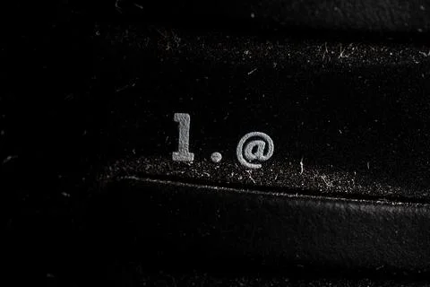 1 and at icon and button close up of a old black Television remote controller Stock Photos