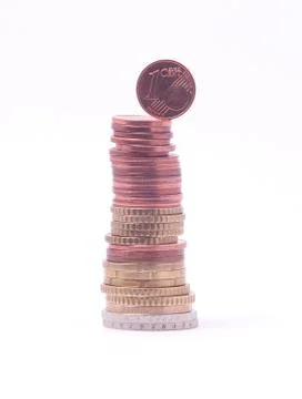 1 cent coin falling from stack of euro coins. symbol for economy, business, i Stockfoto's