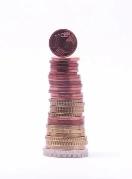 1 cent coin standing on top of stack of euro coins. symbol for economy, busin Stock Photos
