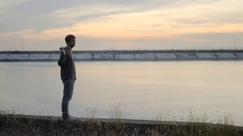 1 guy with bat in hand go. Man hit through air 4k. Maniac carries stick in hand. Stock Footage 72634782