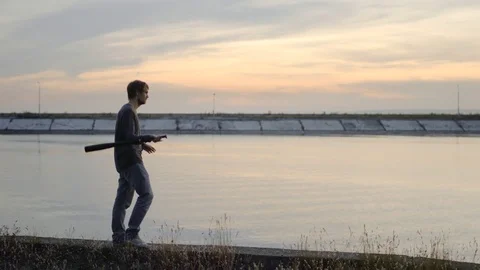1 guy with bat in hand go. Man hit through air 4k. Maniac carries stick in hand. Stock Footage 72635237