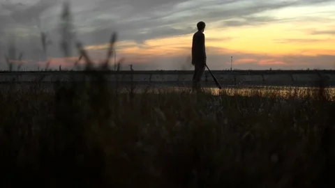 1 guy with bat in hand go. Man hit through air 4k. Maniac carries stick in hand. Stock Footage 72638475