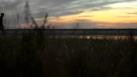 1 guy with bat in hand go. Man hit through air 4k. Maniac carries stick in hand. Stock Footage 72642490