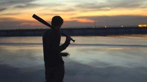 1 guy with bat in hand go. Man hit through air 4k. Maniac carries stick in hand. Stock Footage 72643148