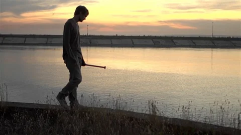 1 guy with bat in hand go. One man hit bat through air. Stock Footage 72643676