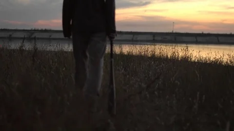 1 guy with bat in hand go. One man hit bat through air. Stock Footage 72643724