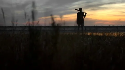 1 guy with bat in hand go. One man hit bat through air. Stock Footage 72643812