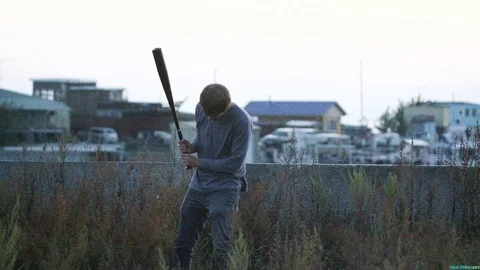 1 guy with bat in hand go. One man hit bat through air. Stock Footage 72643829