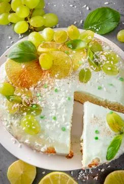 1 homemade cake, pie  with grapes, lime slices,   coconut shavings,  green Ba Stock Photos