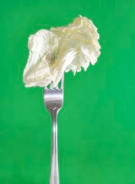 1 lettuce leaf on a fork on a green background Stock Photos