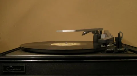 1-Man turns-off 33 LP record on 1960s turntable v3 Stock Footage 7730630