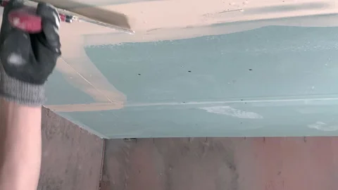 1 Plasterer applies plaster to the ceiling at repair renovation work Video stock 155899372