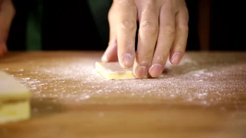 1 Use a rolling pin to thin out the butter slices Stock Footage 236549630