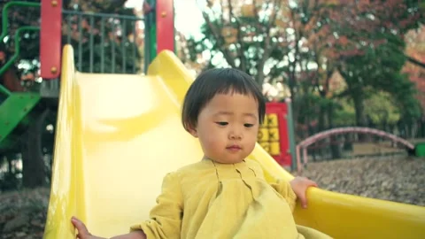 1 year old and four-year-old kid playing on slide Video stock 161858493