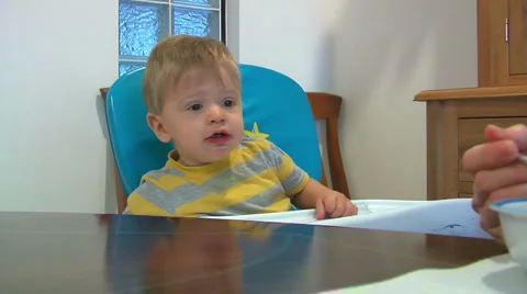 1 year old boy feeding resists mouth wipe Video stock 1060352
