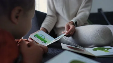 A 1 year old boy with his mum at home. Mom learning new words with baby. Child Stockbeeldmateriaal 171373101