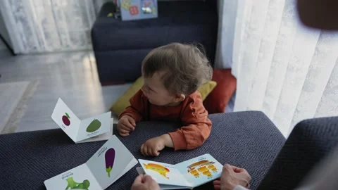 A 1 year old boy with his mum at home. Mom learning new words with baby. Child Video stock 171373184