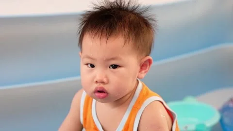 1 year old child playing in the rubber pool Stock Footage 149346469