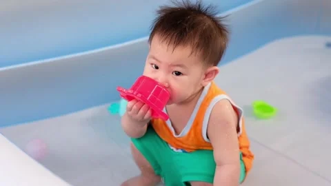 1 year old child playing in the rubber pool Stock Footage 149346470