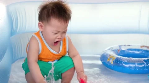 1 year old child playing in the rubber pool Stock Footage 149346471