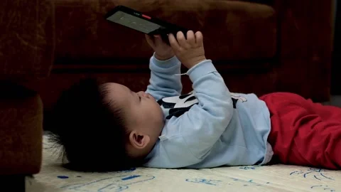 1 year old child sleeps on the phone Stock Footage 149346467