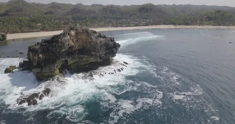10. aerial view, bird view of a large rock in the middle of the ocean hit by  Stock Footage 121700283