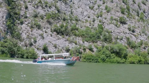 10 July 2026, Iron Gates, Serbia: Tourist boat sailing on a beautiful river Stock Footage 344731004