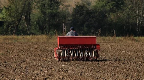 10. Sowing. Seeder for sowing in a field. Tractor preparing land for planting. Stock Footage 43160495