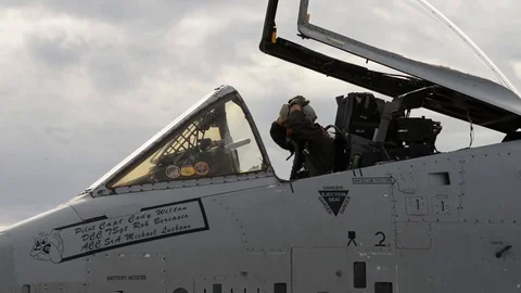 A-10 Thunderbolt II pilot removing cover from flying helmet Stock Footage 104600887