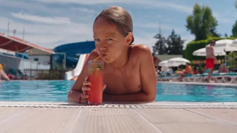 10 year old boy enjoying his holiday at the hotel. Drinking a cocktail in the Video stock 285601258
