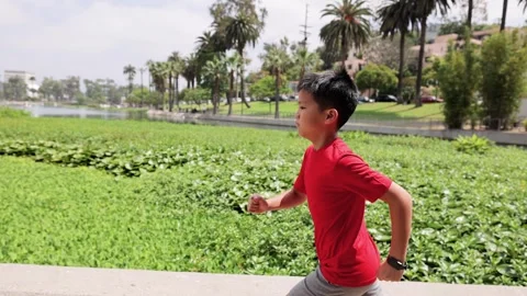 10 Year Old Boy Jogging In a Park in Los Angeles 動画素材 292292003