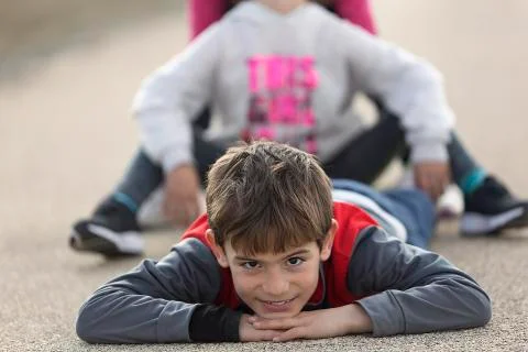 10 year old boy lying on the floor looking towards the camera. Stock Photos