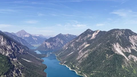 100 characters remaining Description*: Plansee stretches through the mountains Stock Footage 346119564
