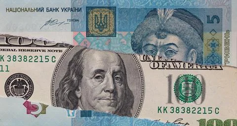 100 dollar banknote through torn 5 Urainian hryvnia banknote Stock Photos