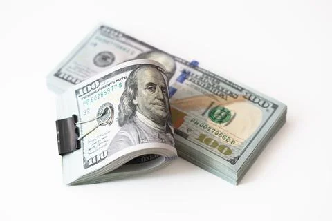 100 dollar banknotes with binder clip on dollars background Stock Photos
