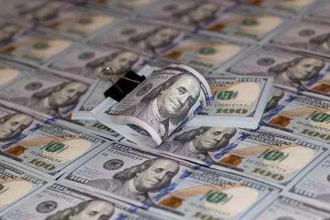 100 dollar banknotes with binder clip on dollars background Stock Photos