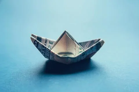 100 dollar bill in the shape of a ship. Stock Photos