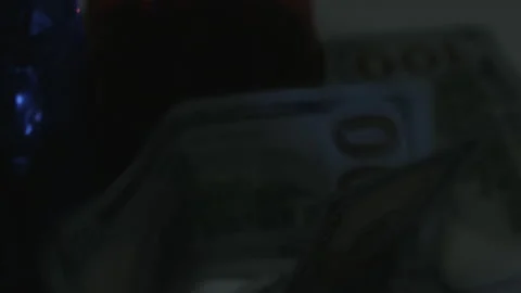 100 Dollar Bills Fall Onto Rotating Police Lights 4K Video stock 217853802