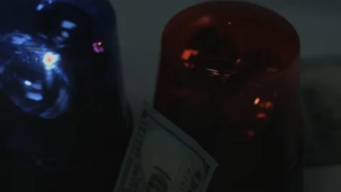 100 Dollar Bills Fall Onto Rotating Police Lights 4K Video stock 217855463